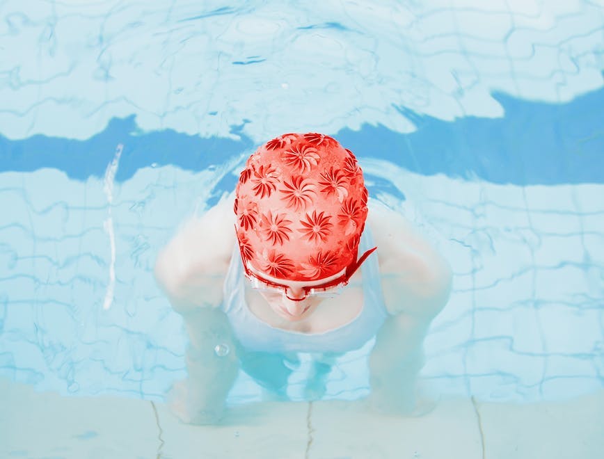 clothing apparel swimming sport sports water person bathing cap cap hat